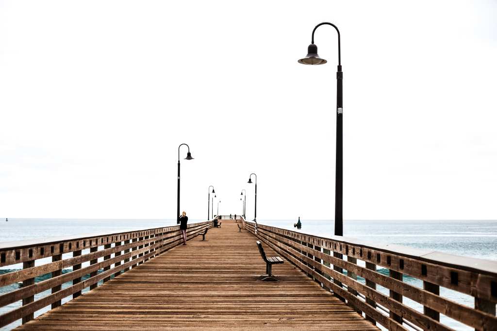 Photo of woman standing on pier