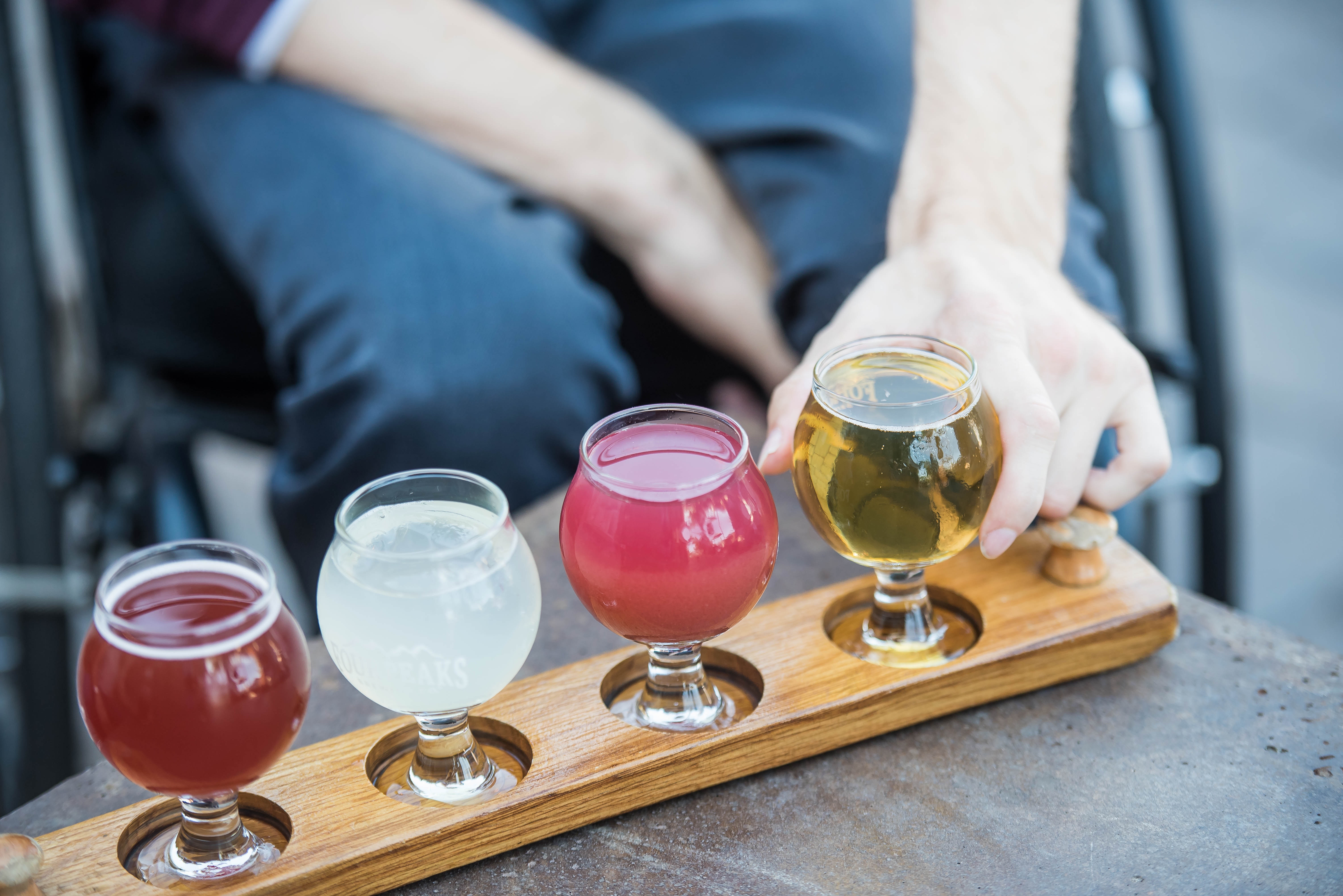 Four tasting glasses on a wooden board