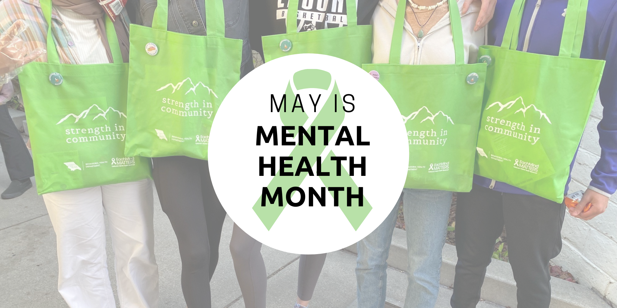 Students holding green canvas bags with text overlay that reads "May is mental health month." 