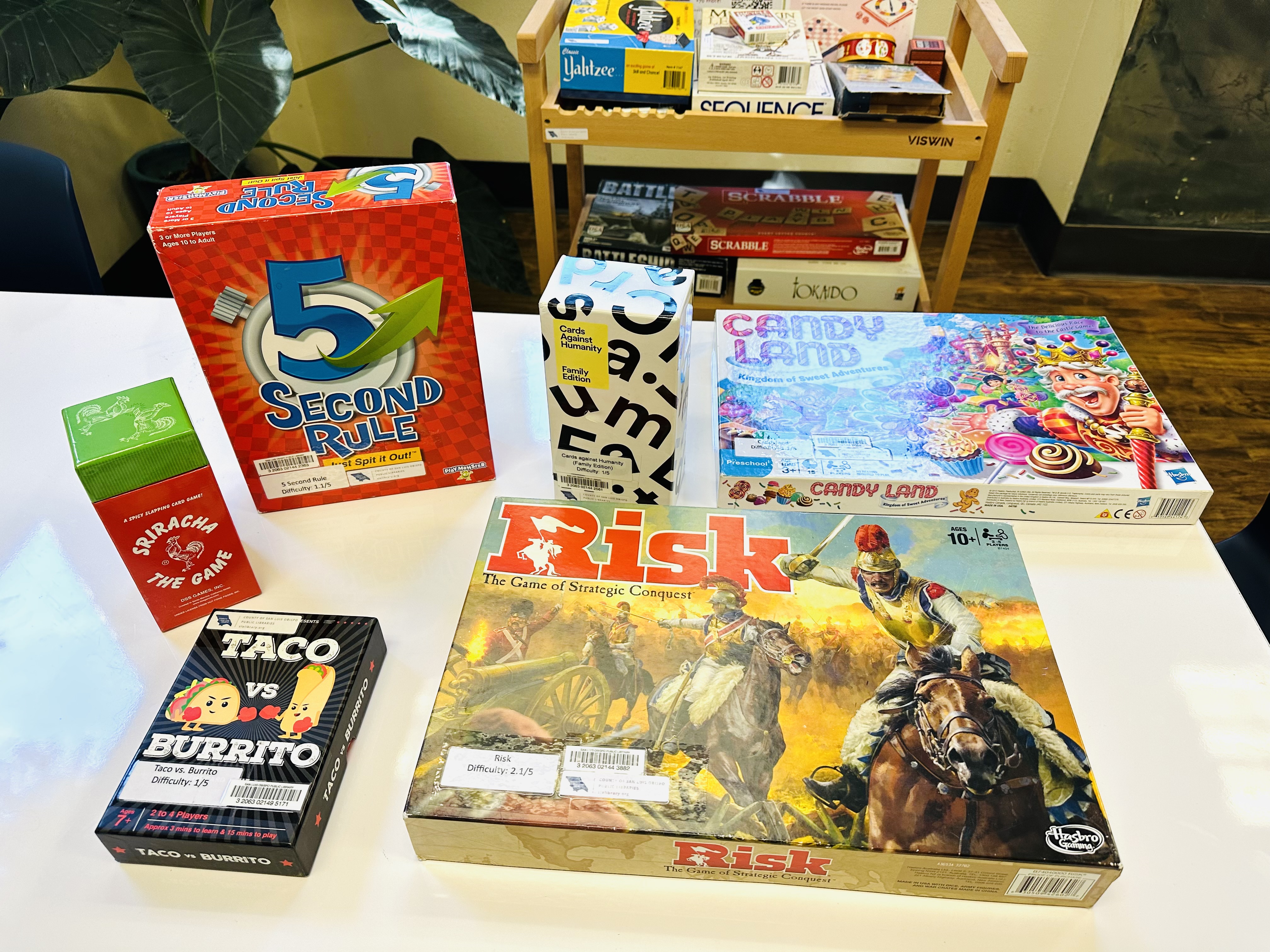 A table display showing a variety of board games