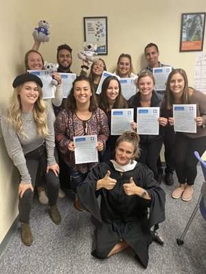 A group of students holding completion certificates for Mental Health First Aid.