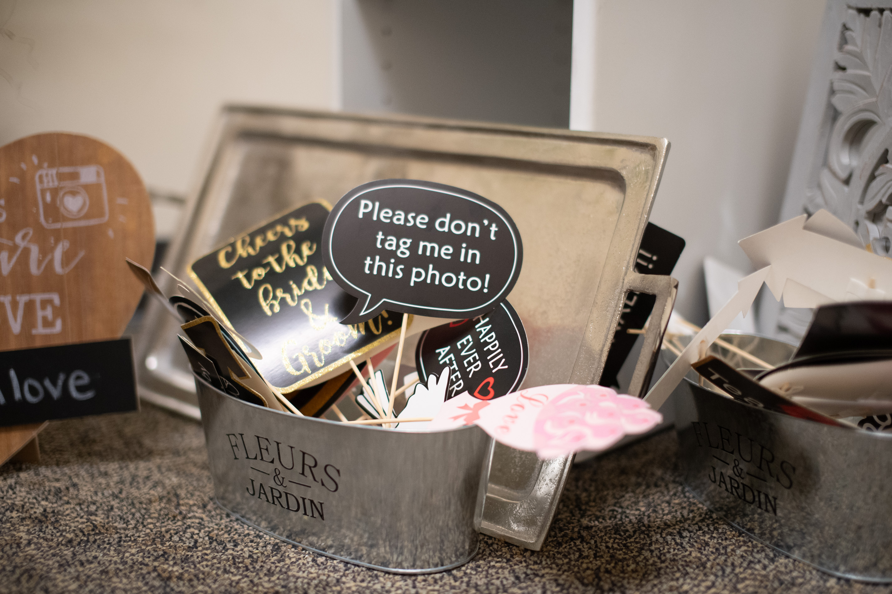 Whimsical handheld signs that say things like "Cheers to the bride and groom"