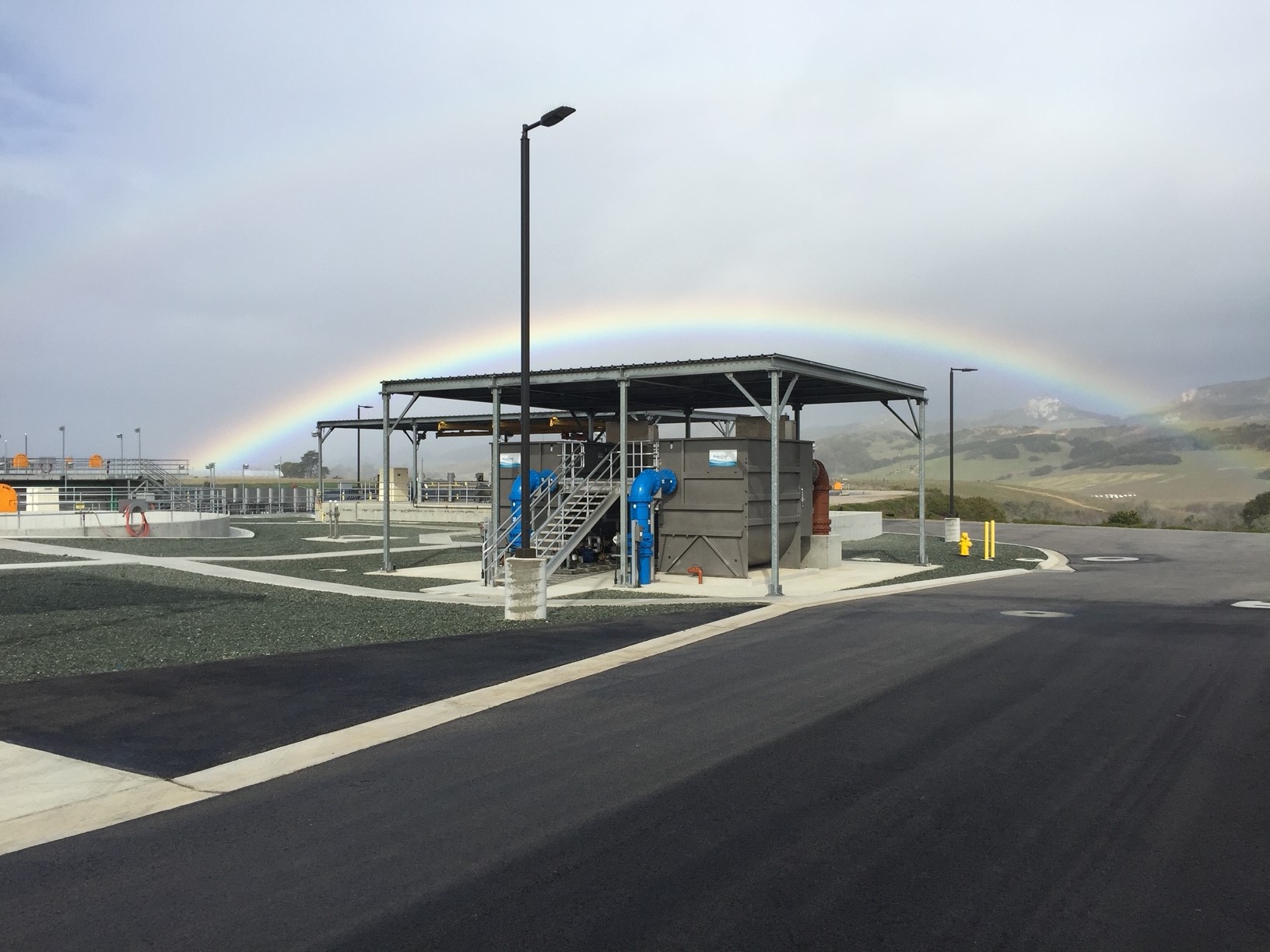 Rainbow over LOWRF facility with mountains in background