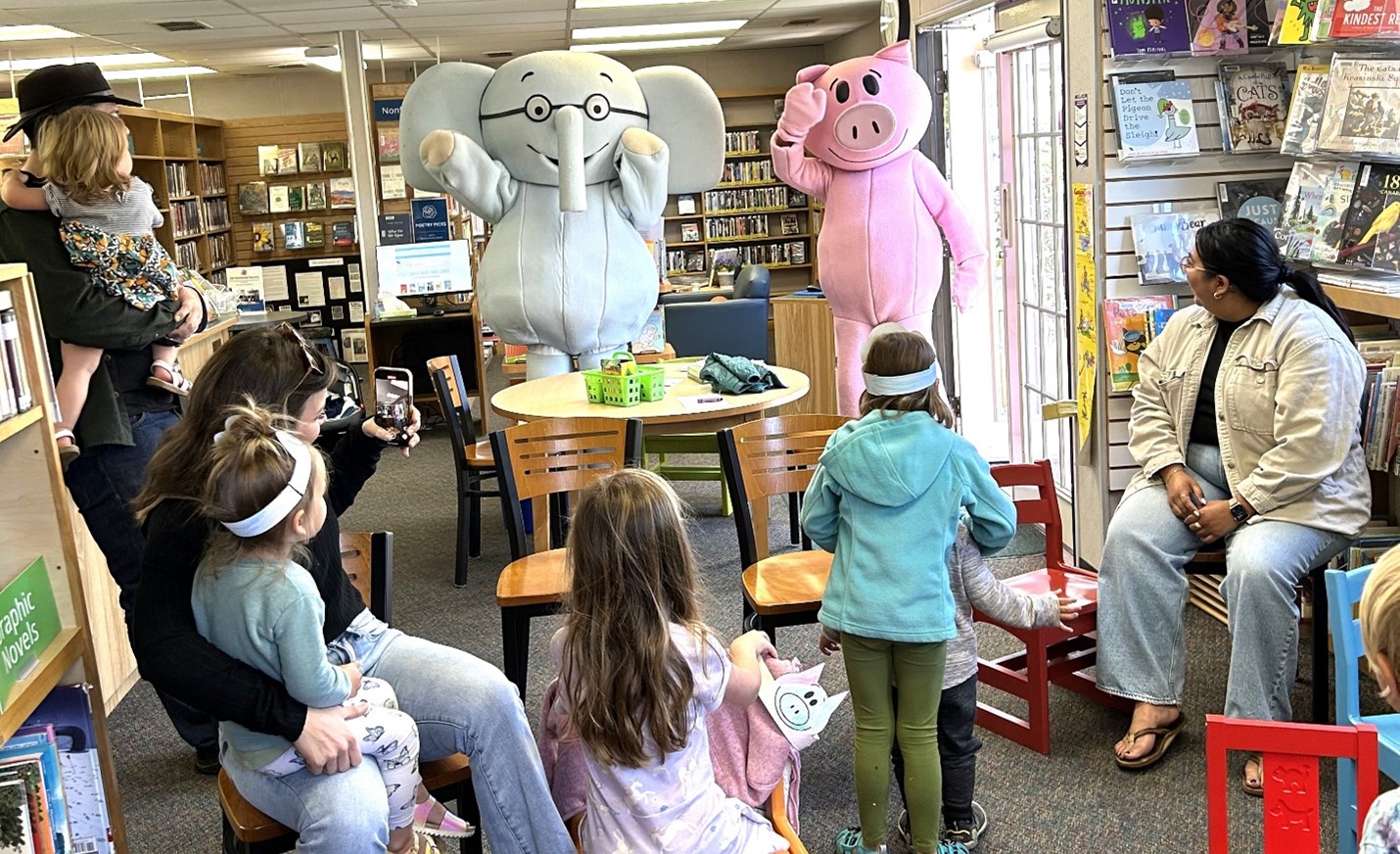 Image showing mascots in elephant and pig costumes waving to children at the Santa Margarita Library