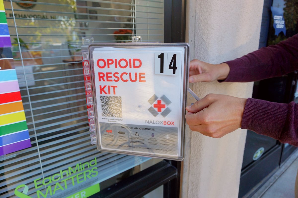 Person accessing a community NaloxBox. 