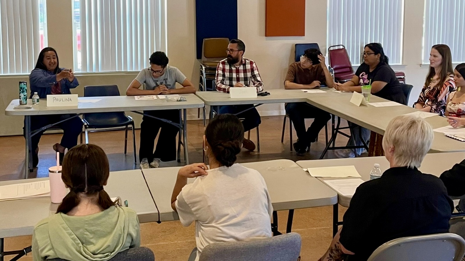 Public Health professionals sitting with teens, discussing the field.