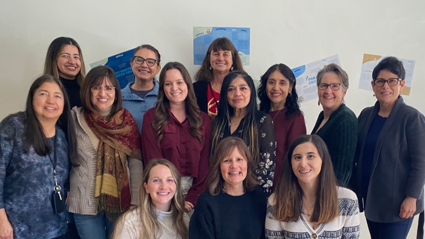 Thirteen women on the SLO County WIC team standing together smiling.